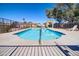 Community pool with clear blue water, pergola, and a safety fence, perfect for relaxation and recreation at 1336 E Mountain View Rd # 209, Phoenix, AZ 85020