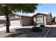 A single story home in a desert landscape showcases a front-facing garage and a low maintenance yard at 1384 E Las Colinas Dr, Chandler, AZ 85249