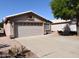A well-maintained front yard with a spacious driveway leading to an attached two-car garage at 1384 E Las Colinas Dr, Chandler, AZ 85249