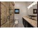 Modern bathroom with glass enclosed shower, vanity with marble countertop, and stylish fixtures at 1423 E Beverly Ln, Phoenix, AZ 85022