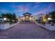 Stunning home exterior featuring a brick driveway and an elegant entrance with manicured landscaping at 1423 E Beverly Ln, Phoenix, AZ 85022