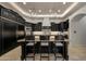 Elegant kitchen with dark cabinetry, granite countertops, stainless steel appliances, and a functional island at 1423 E Beverly Ln, Phoenix, AZ 85022
