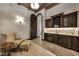 Elegant space with custom wet bar, cabinets, wooden beam ceiling and arched entry at 1423 E Beverly Ln, Phoenix, AZ 85022