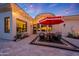 Cozy outdoor patio featuring a comfortable seating area beneath a red umbrella, perfect for entertaining at 1423 E Beverly Ln, Phoenix, AZ 85022