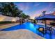 Gorgeous pool with a waterfall, lush landscaping, and cozy seating, creating a relaxing backyard oasis at 1423 E Beverly Ln, Phoenix, AZ 85022