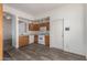 A cozy kitchen with wood cabinets, white appliances, and wood-look flooring at 16112 W Buchanan St, Goodyear, AZ 85338
