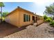 This backyard features neutral toned stucco walls, a covered patio and gravel ground cover at 16906 W Palm Ln, Goodyear, AZ 85395
