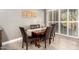 Cozy dining room featuring a wooden table with six chairs and natural light at 16906 W Palm Ln, Goodyear, AZ 85395