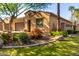 Landscaped front lawn with lush green grass complements this charming single Gathering home at 16906 W Palm Ln, Goodyear, AZ 85395