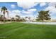 Picturesque golf course with a serene pond and fountains amidst lush green fairways at 16906 W Palm Ln, Goodyear, AZ 85395