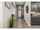 Welcoming hallway features wood flooring, neutral paint, and decorative accents at 16906 W Palm Ln, Goodyear, AZ 85395