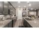 Spacious kitchen with stainless steel appliances, granite countertops, and gray cabinets provides modern elegance at 16906 W Palm Ln, Goodyear, AZ 85395