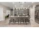 Open-concept kitchen with island seating, pendant lights, and modern appliances offers seamless living at 16906 W Palm Ln, Goodyear, AZ 85395