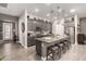 Modern kitchen features gray cabinets, granite countertops, stainless steel appliances, and a large island with seating at 16906 W Palm Ln, Goodyear, AZ 85395