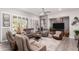 Spacious living room features a ceiling fan, recessed lighting, and abundant natural light from windows with plantation shutters at 16906 W Palm Ln, Goodyear, AZ 85395