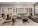 Inviting living room features neutral decor, modern furniture, and plantation shutters on bright windows at 16906 W Palm Ln, Goodyear, AZ 85395