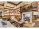 Inviting lobby area featuring a cozy fireplace, bookshelves, and comfortable seating for relaxation at 16906 W Palm Ln, Goodyear, AZ 85395