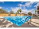 Outdoor swimming pool with lane markers, surrounded by a patio, and ample lounge chairs for relaxation at 16906 W Palm Ln, Goodyear, AZ 85395