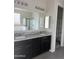 Bathroom boasts double sinks, marble countertops, and a walk-in closet at 1702 N 214Th Ln, Buckeye, AZ 85396
