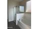 Bright bathroom features a glass-enclosed shower and soaking tub at 1702 N 214Th Ln, Buckeye, AZ 85396