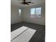 Well-lit bedroom with large windows, plush carpet and ceiling fan at 1702 N 214Th Ln, Buckeye, AZ 85396