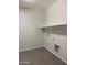 Large laundry room with tile floors and shelving at 1702 N 214Th Ln, Buckeye, AZ 85396