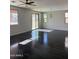 Bright open-plan living space, dark wood floors, and abundant natural light from multiple windows at 1702 N 214Th Ln, Buckeye, AZ 85396