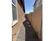Side yard with rock cover and block wall at 1702 N 214Th Ln, Buckeye, AZ 85396