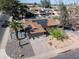 Aerial view of the home, showcasing the landscaped front yard, driveway, and solar panels on the roof at 1720 E Intrepid Ave, Mesa, AZ 85204
