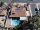 An aerial view of a home featuring a backyard pool, covered patio, and solar panels at 1720 E Intrepid Ave, Mesa, AZ 85204