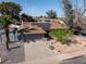 Aerial view of the home, showcasing the landscaped front yard, driveway, and solar panels on the roof at 1720 E Intrepid Ave, Mesa, AZ 85204