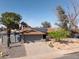 Aerial view of the home, showcasing the landscaped front yard, driveway, and solar panels on the roof at 1720 E Intrepid Ave, Mesa, AZ 85204