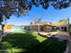 Spacious backyard with a refreshing pool, lush artificial grass, and covered patio area perfect for outdoor relaxation at 1720 E Intrepid Ave, Mesa, AZ 85204