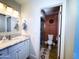 Well-lit bathroom featuring a vanity with granite counters and a shower at 1720 E Intrepid Ave, Mesa, AZ 85204