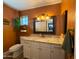 Charming bathroom with granite countertop vanity, a hanging plant and decorative accents at 1720 E Intrepid Ave, Mesa, AZ 85204