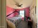 Cozy bedroom with a double bed, ceiling fan, natural light, and creative wall design at 1720 E Intrepid Ave, Mesa, AZ 85204
