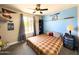 Bright bedroom with a ceiling fan, window views, and baseball-themed decorations at 1720 E Intrepid Ave, Mesa, AZ 85204