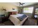 Serene bedroom featuring a large window, wooden furniture, and neutral decor at 1720 E Intrepid Ave, Mesa, AZ 85204