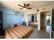 Comfortable bedroom featuring a ceiling fan, mirrored closet, and ample natural light at 1720 E Intrepid Ave, Mesa, AZ 85204