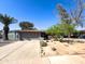 Charming single-story home featuring desert landscaping, a spacious driveway, and a welcoming facade at 1720 E Intrepid Ave, Mesa, AZ 85204