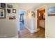 Hallway leading to a bedroom and bathroom; features wood-look flooring and wall decor at 1720 E Intrepid Ave, Mesa, AZ 85204