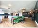 An open floor plan connecting the kitchen to the living room with wood floors and a green couch at 1720 E Intrepid Ave, Mesa, AZ 85204