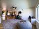 A spacious living room with wood floors, a comfortable beanbag chair, and large windows at 1720 E Intrepid Ave, Mesa, AZ 85204