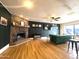 A living room featuring a stone fireplace, wood floors, and a comfortable green couch at 1720 E Intrepid Ave, Mesa, AZ 85204