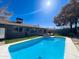 Inviting backyard pool with a sunny patio area and well-maintained landscaping at 1720 E Intrepid Ave, Mesa, AZ 85204