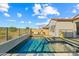 Serene backyard oasis with a clear swimming pool, lounge chairs, and beautiful golf course views at 17396 W Crawfordsville Dr, Surprise, AZ 85388
