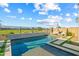 Beautiful backyard featuring a sparkling pool, sun loungers, and views of the green golf course at 17396 W Crawfordsville Dr, Surprise, AZ 85388
