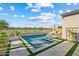 Inviting backyard with a refreshing pool, comfortable seating, and a serene golf course view at 17396 W Crawfordsville Dr, Surprise, AZ 85388