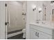 Bright bathroom featuring a glass-enclosed shower with sleek tile and a double sink vanity at 17396 W Crawfordsville Dr, Surprise, AZ 85388