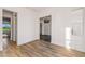 Bright hallway featuring wood tile floors and a view to the outside patio at 17396 W Crawfordsville Dr, Surprise, AZ 85388